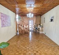 Interior of a family house with a wooden decor floor and a wooden ceiling.