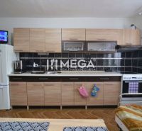 A kitchen in a family house with wooden decor flooring and light furniture.