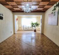 Living room in a family house with a wooden decor floor and a chandelier.