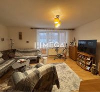 Living room in a family house with a sofa, table, television, and floor with a wooden decor.
