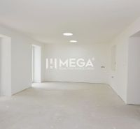 A view of an empty room in a 3-room apartment with large windows and white walls.