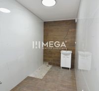 A bathroom with large-format tiles and a floor with a wooden decor in a 3-room apartment.