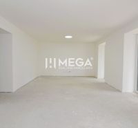 White empty room with a concrete floor in a 3-room apartment.