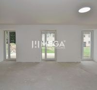 A spacious room in a 3-room apartment with large windows and a view of the garden.