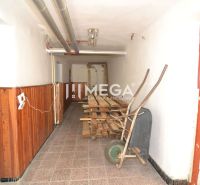 A hallway with a PVC floor, wooden paneling, and pipes in a family house.