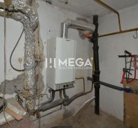 Boiler room in a family house with a piping system and a water tank.