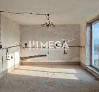 An unfinished interior in a family house with an empty room and a window.
