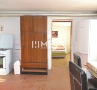 Kitchen in a family house with a gas stove, refrigerator, and dining table.