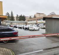 Parking lot in front of the offices on 26th November Street in Humenné with a barrier and cars.