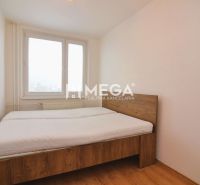 A bedroom with a bed and a wooden decor floor in a 2-room apartment.