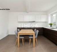 Kitchen commercial space with wood-patterned flooring and white cabinets.