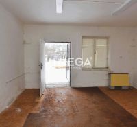Interior of commercial spaces with wood-patterned flooring and white walls.