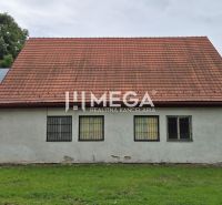 Commercial premises in Zboj with a sloped roof and windows with built-in bars.