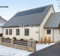 A house with a sloped roof and wooden cladding in winter Zboj, commercial premises.