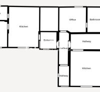 Floor plan of a family house with a garage, two kitchens, and two bathrooms.
