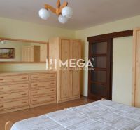 A bedroom in a family house with wooden furniture and a wooden decor floor.