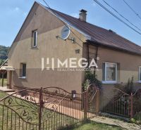 A family house in Krásny Brod with a well-maintained garden and a satellite dish.
