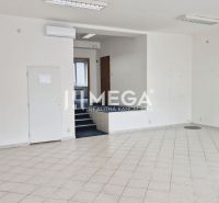 Empty commercial spaces with white walls and ceramic tiles on the floor.