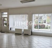 Interior of commercial premises with large windows and tiled floor.