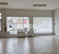 Spacious commercial spaces with large windows and tiled floors.