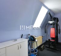 A room in a family house with sports equipment and furniture.