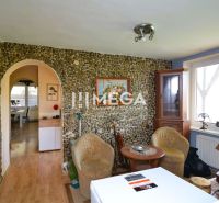 Interior of a family house with a stone wall, furniture, and flooring with a wooden decor.