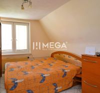 Bedroom in a family house with a bed and built-in wardrobe, cozy environment.