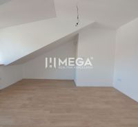 Attic room with wooden decor flooring in a 2-room apartment.