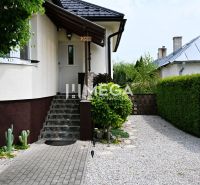 Entrance to a family house in Udavské with a stone walkway and a landscaped garden.