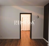 Interior of a family house with a wooden decor floor and curtains on the windows.