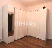 Interior of a family house with a wooden decor floor and simple white furniture.