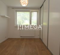 A room with a wooden decor floor and a built-in wardrobe in a family house.