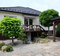 A family house in Udavské with a well-maintained garden and a stone driveway.