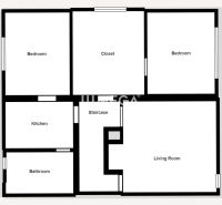 Floor plan of a family house with two bedrooms, a living room, a kitchen, and a bathroom.