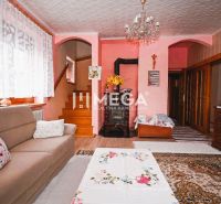 Living room in a family house with a fireplace and a wooden decor floor.