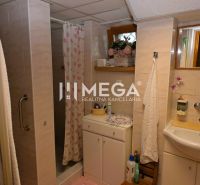 A bathroom in a family house with a shower and floral decorations.