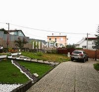 The garden of a family house on Sídlisko Poľana in Humenné with cars and greenery.