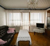 Living room in a family house with a leather sofa and wooden decor flooring.