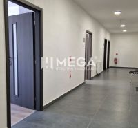 A corridor with multiple offices, tiled flooring, and open doors in the offices.