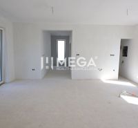 A spacious room in a family house with windows and unfinished work.