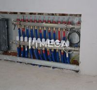 Distribution cabinet of installations in the interior of a family house with blue and red pipes.