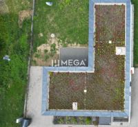 A family house on Gaštanová Street in Humenné with a green roof and a yard.