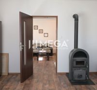 In the family house, there are a stove, cabinets, doors, and a floor with a wooden decor.