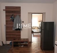 Interior of a family house with a wooden decor floor, hallway, and coat rack.