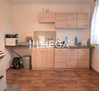 A kitchen in a family house with a wooden floor decor and light furniture.