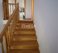 Staircase with railing, door, wooden decor flooring in a family house.