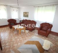 Interior of a family house with leather sofas and ceramic flooring.