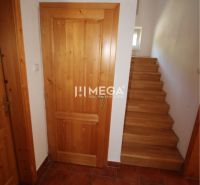 A family house with wooden doors and staircase, floor with wooden decor.