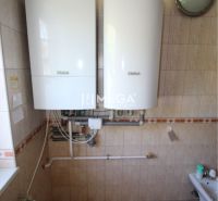 A bathroom in a family house with Vaillant gas boilers and wall tiles.