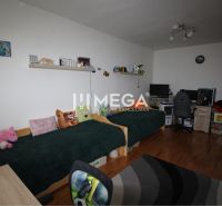 Children's room in a two-room apartment with a bed, a desk, and a floor with a wooden decor.